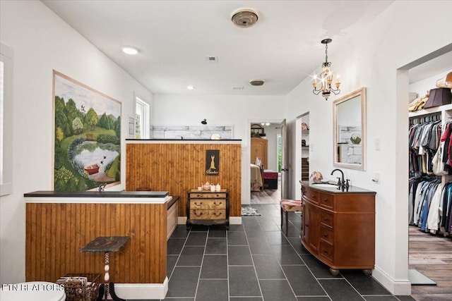 bathroom featuring vanity, a chandelier, and tile patterned flooring