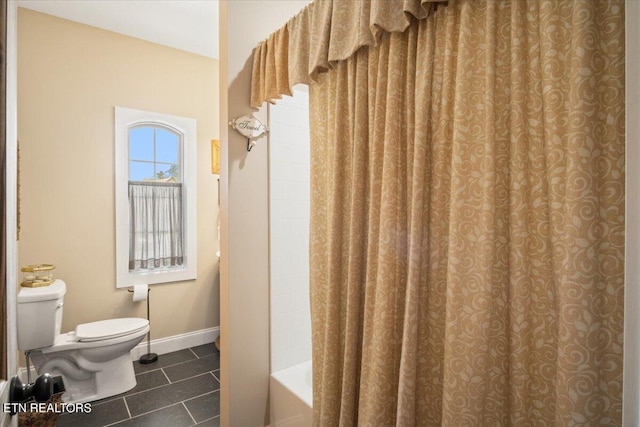 bathroom featuring shower / bathtub combination with curtain, toilet, and tile patterned flooring