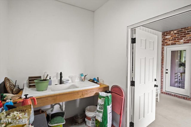 bathroom featuring brick wall