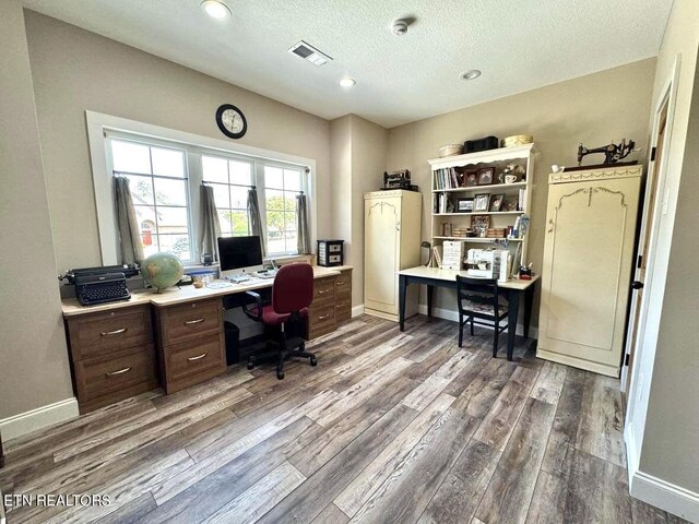 office area featuring dark hardwood / wood-style flooring and a textured ceiling