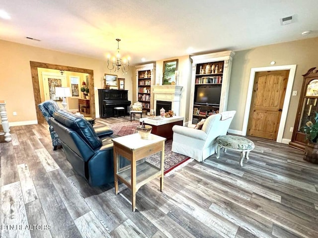 living room featuring wood-type flooring and a chandelier