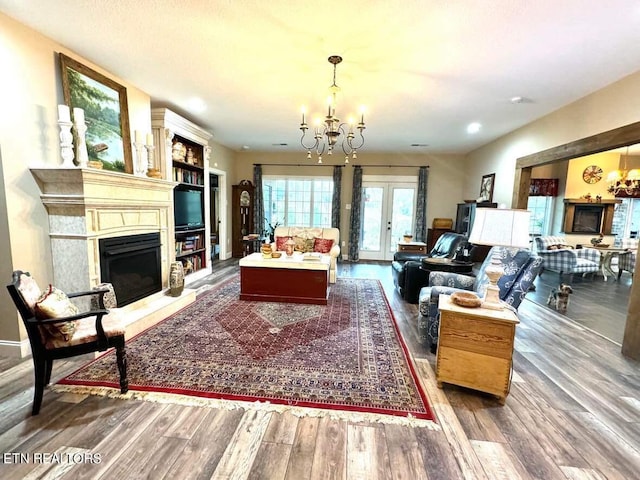 living room with hardwood / wood-style floors and an inviting chandelier