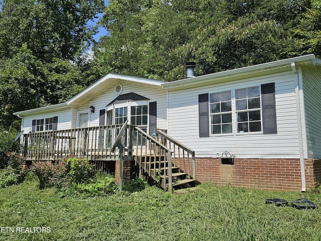 manufactured / mobile home featuring a front lawn, crawl space, and a deck