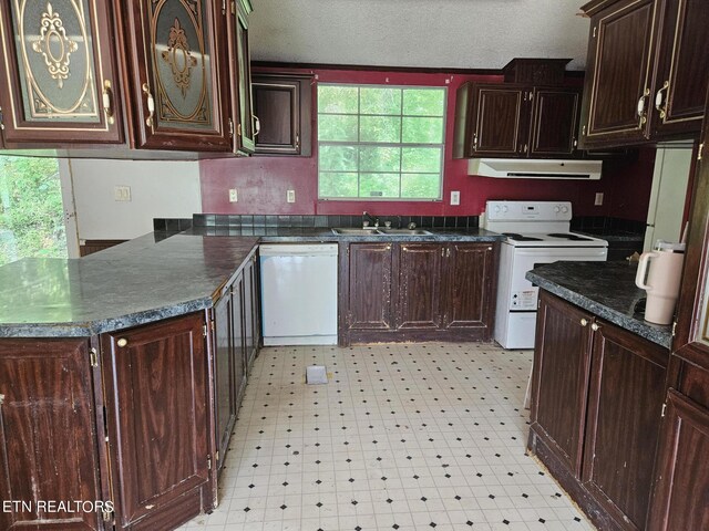 kitchen featuring extractor fan, dark countertops, light floors, and white appliances