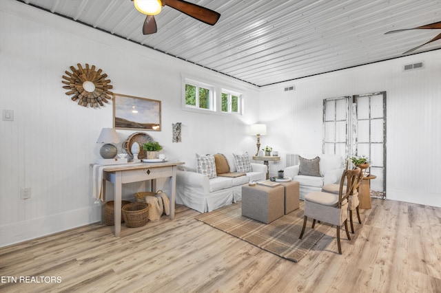 living room with ceiling fan and light hardwood / wood-style flooring