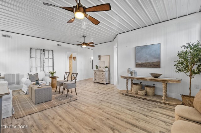 living room featuring light hardwood / wood-style floors and ceiling fan