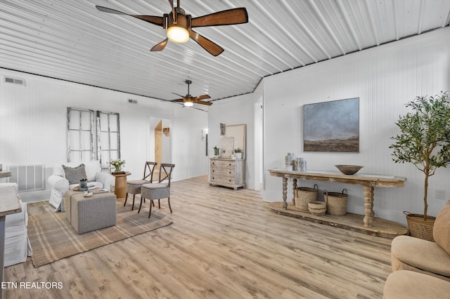 living room with visible vents, ceiling fan, and wood finished floors