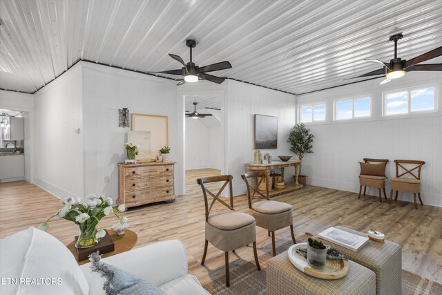 living room featuring ceiling fan and light hardwood / wood-style floors