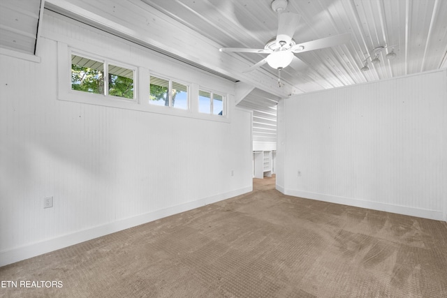 spare room featuring carpet flooring, a ceiling fan, and baseboards