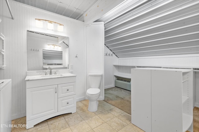 bathroom featuring vanity, vaulted ceiling, and toilet