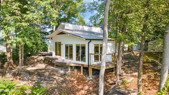 back of property featuring metal roof