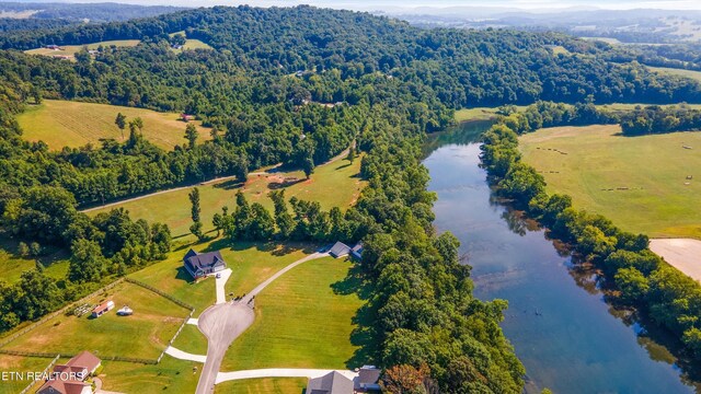 drone / aerial view featuring a water view and a rural view