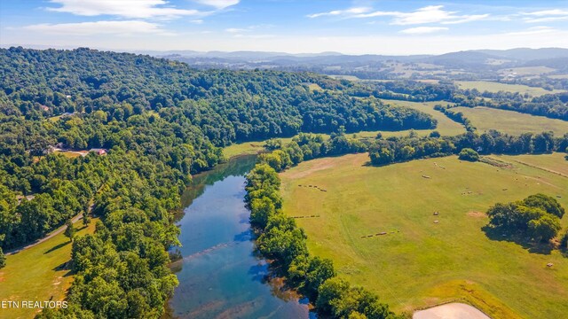 drone / aerial view featuring a water and mountain view