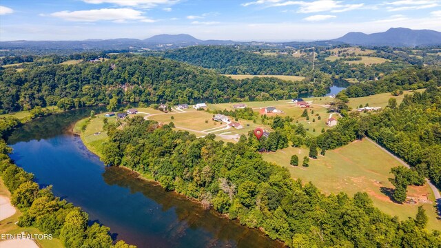 drone / aerial view featuring a water and mountain view