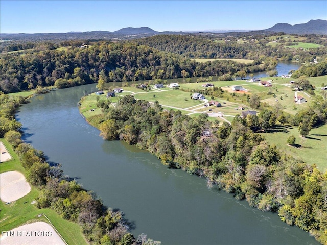 drone / aerial view with a water and mountain view