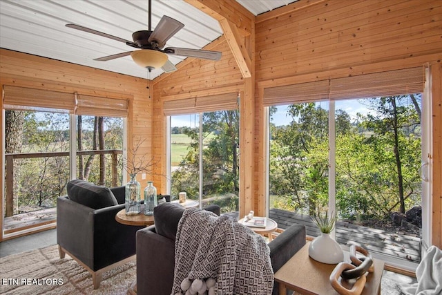 sunroom featuring lofted ceiling and ceiling fan