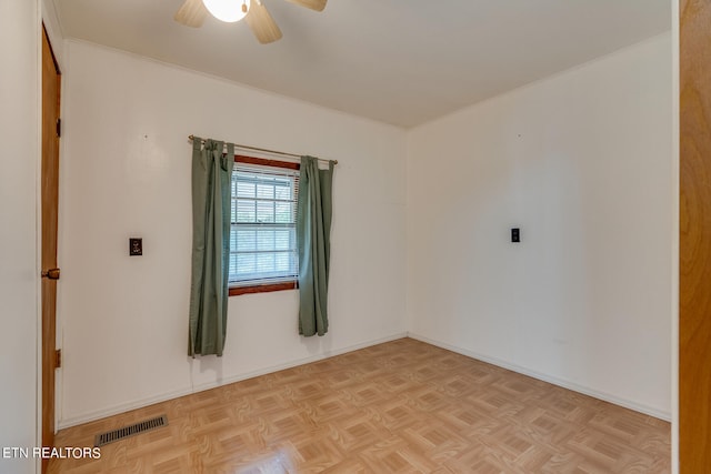 empty room featuring light parquet floors and ceiling fan