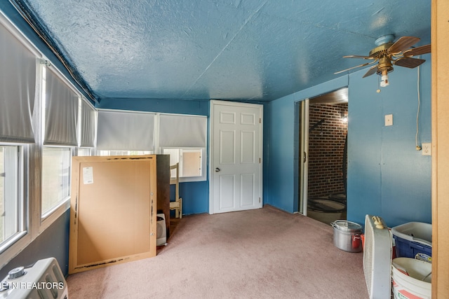 carpeted bedroom featuring a textured ceiling, ceiling fan, and vaulted ceiling