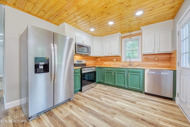 kitchen featuring white cabinets, stainless steel appliances, sink, and green cabinetry