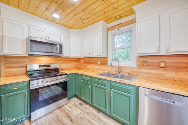 kitchen featuring appliances with stainless steel finishes, sink, and butcher block countertops