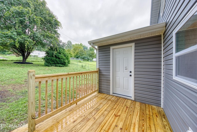 wooden deck with a lawn