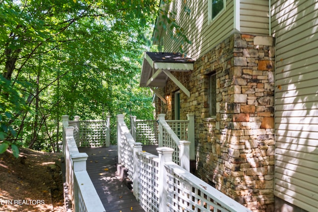 view of property exterior with a wooden deck