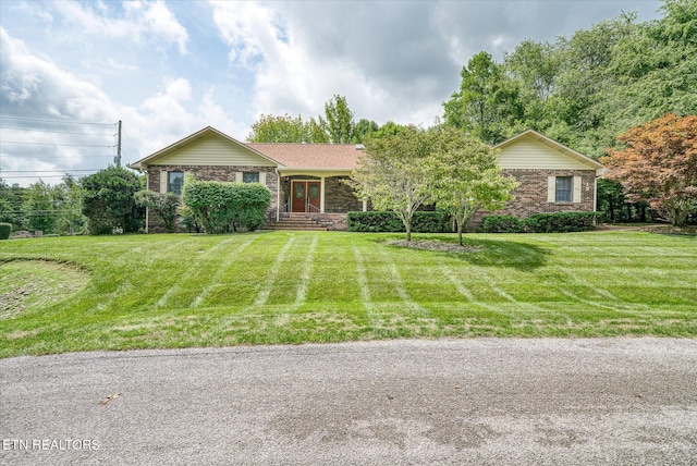 single story home with a front yard and brick siding