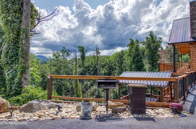 exterior space with a wooden deck and a gazebo