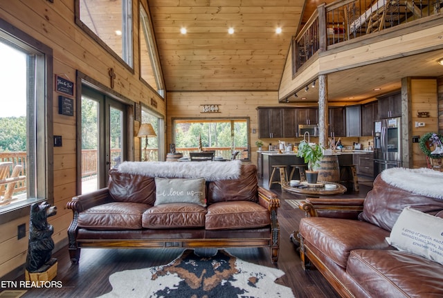 living room with wood walls, dark hardwood / wood-style flooring, wood ceiling, and high vaulted ceiling