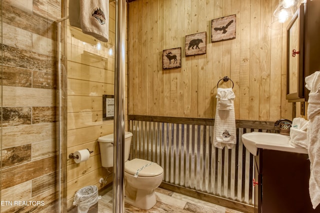 bathroom with toilet and wooden walls