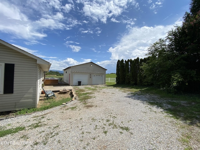 exterior space featuring a garage and an outdoor structure