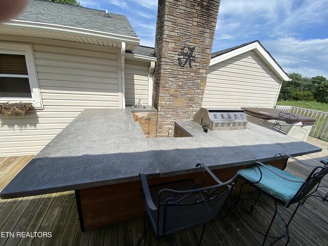 deck with grilling area and exterior kitchen