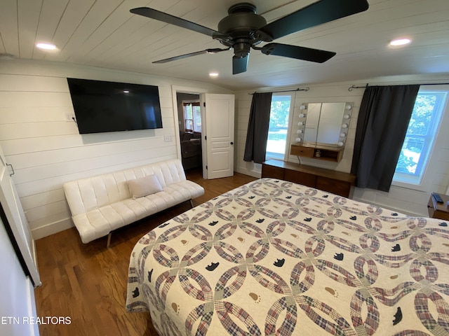 bedroom with wood ceiling, dark hardwood / wood-style flooring, multiple windows, and wood walls