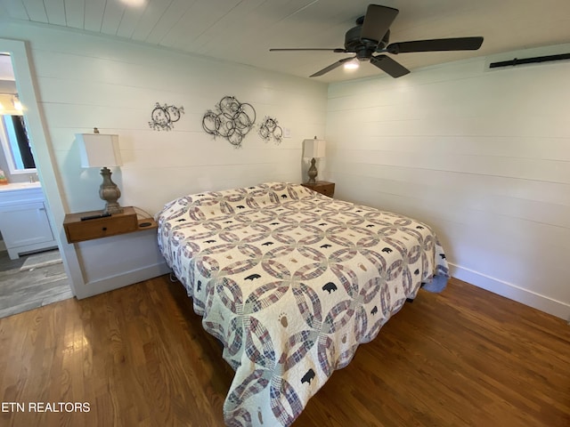 bedroom with dark hardwood / wood-style flooring and ceiling fan