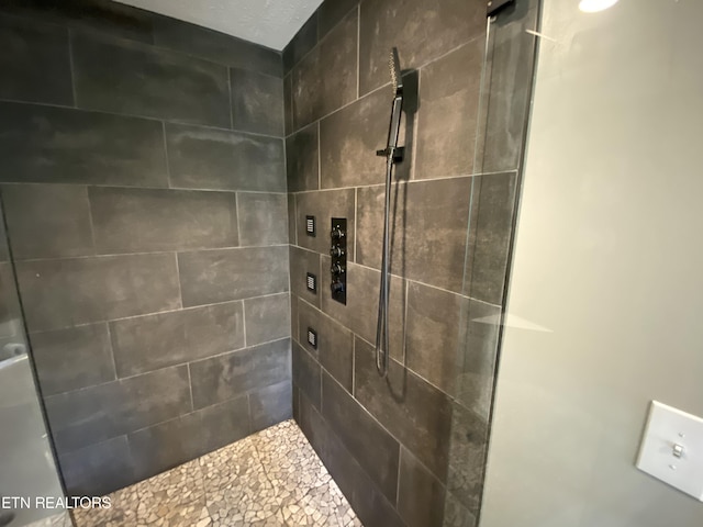 bathroom with tiled shower