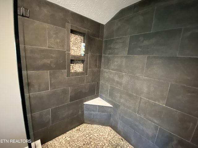 bathroom with tiled shower