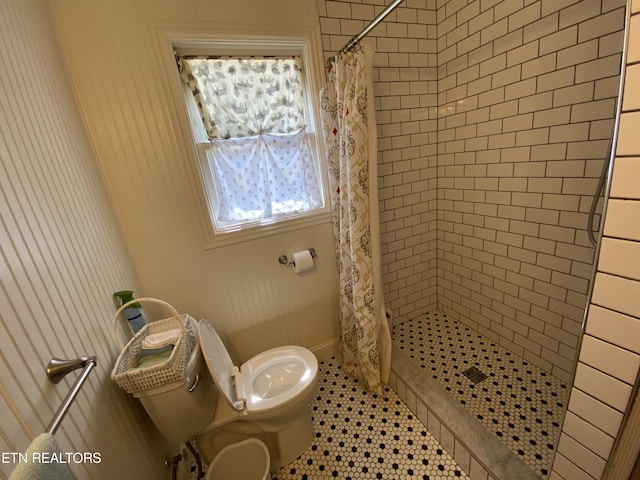 bathroom featuring tile patterned floors, toilet, and a shower with shower curtain