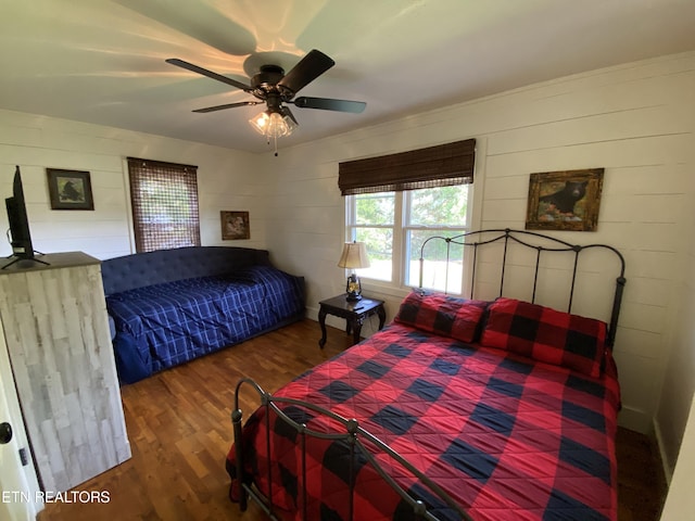 bedroom with ceiling fan and dark hardwood / wood-style floors