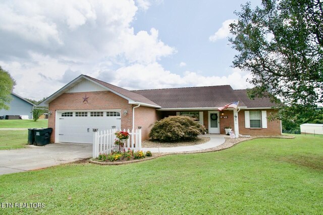 ranch-style home with a garage and a front yard