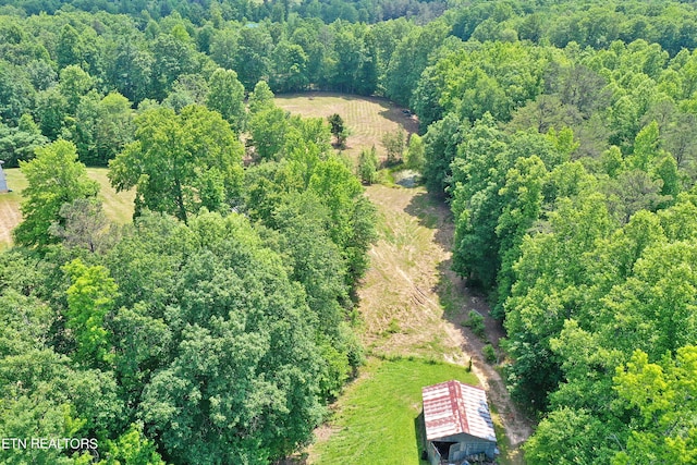 birds eye view of property featuring a wooded view