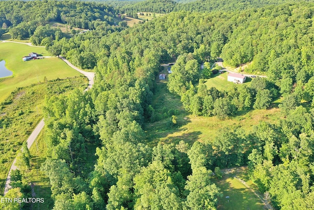 birds eye view of property with a wooded view