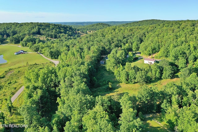 aerial view featuring a wooded view