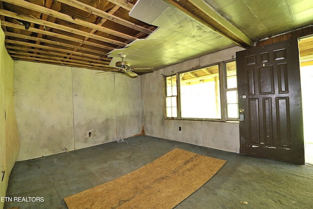 interior space with ceiling fan