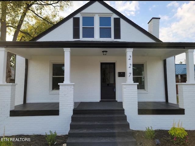 227 Gill St, Alcoa, TN 37701 - bungalow-style house featuring a porch, brick siding, and a chimney