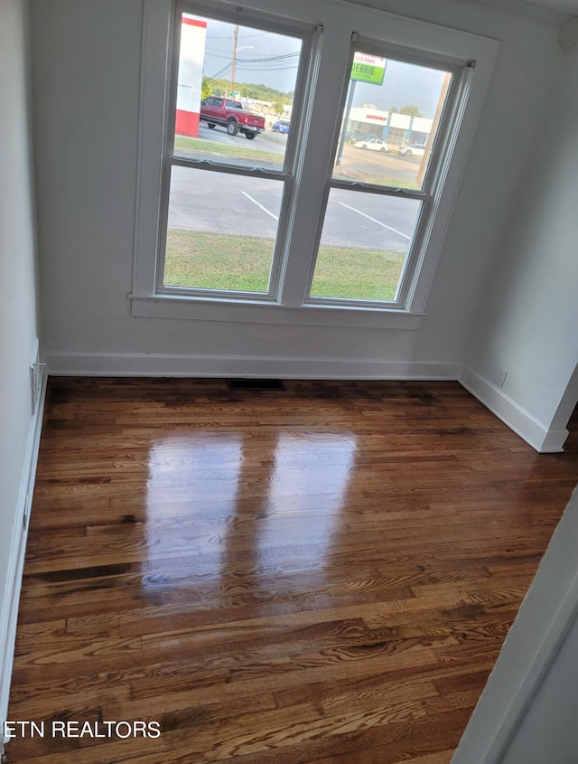 unfurnished room featuring dark hardwood / wood-style flooring