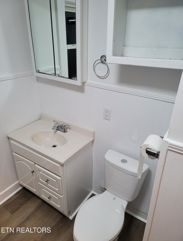 bathroom featuring vanity, hardwood / wood-style floors, and toilet