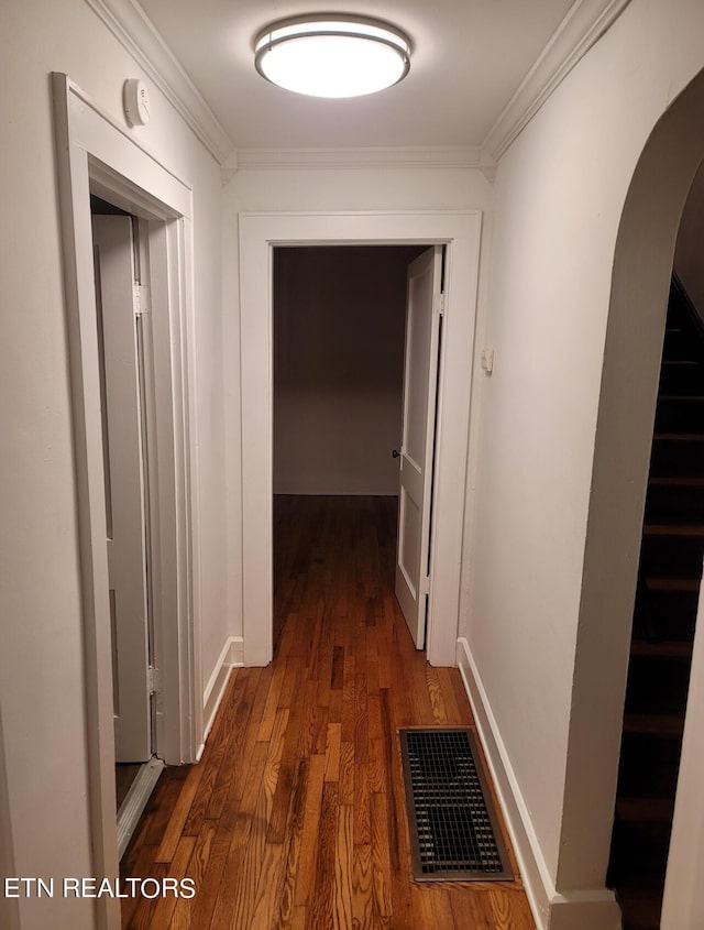 227 Gill St, Alcoa, TN 37701 - hall featuring arched walkways, dark wood-style flooring, ornamental molding, stairs, and baseboards