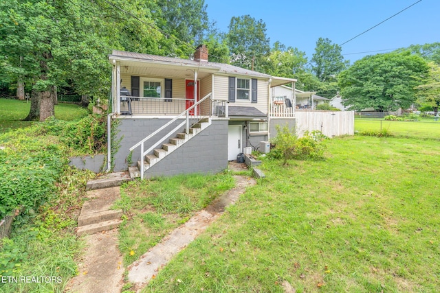 view of front of home featuring covered porch and a front lawn