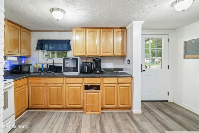 kitchen featuring sink, white electric stove, a textured ceiling, and light wood-type flooring