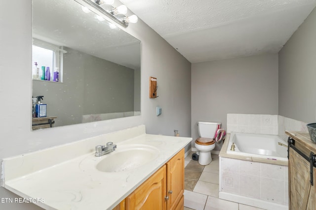 bathroom featuring vanity, toilet, a textured ceiling, and a relaxing tiled tub